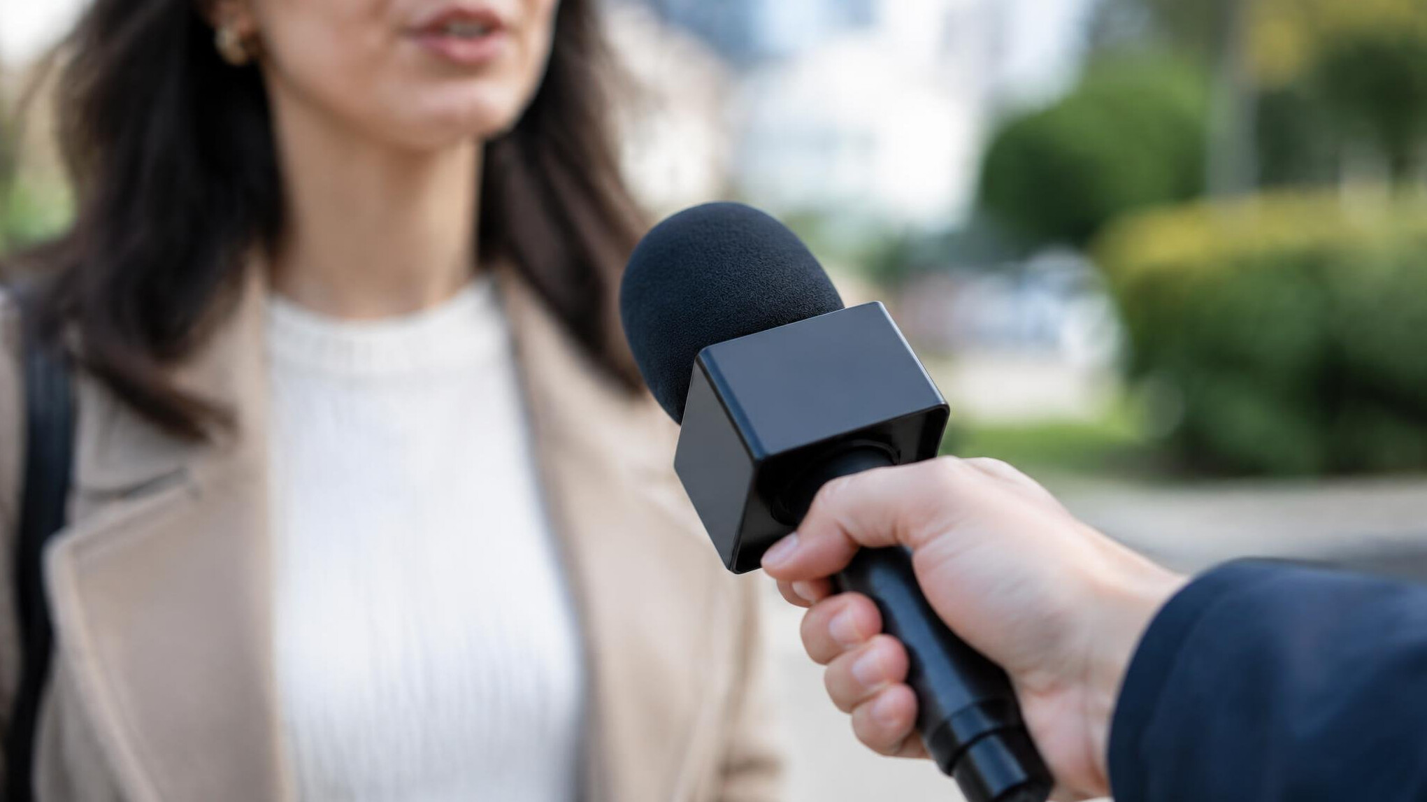 Reporter holding a microphone during an interview